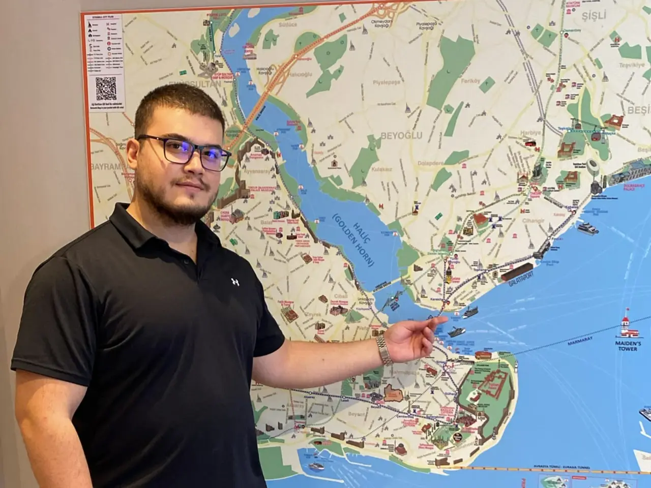 Emirhan, licensed Istanbul tour guide, planning a route on an Istanbul map
